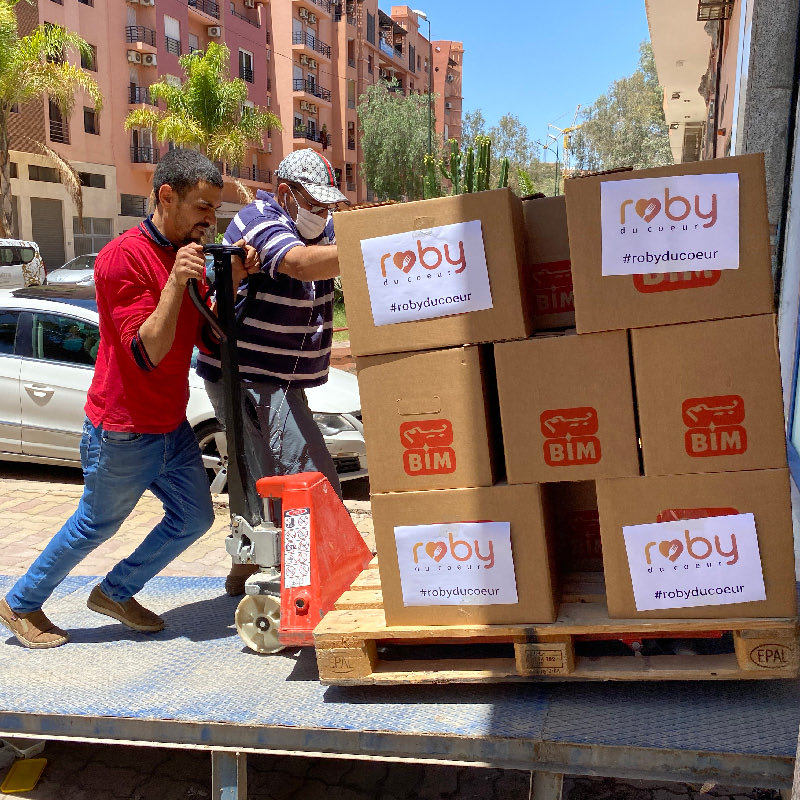 Boxes of donations being loaded into a truck.